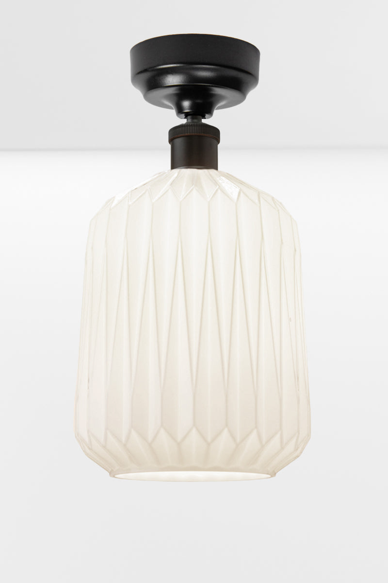 Modern geometric detailed opal glass shade, paired with a black batten holder. 