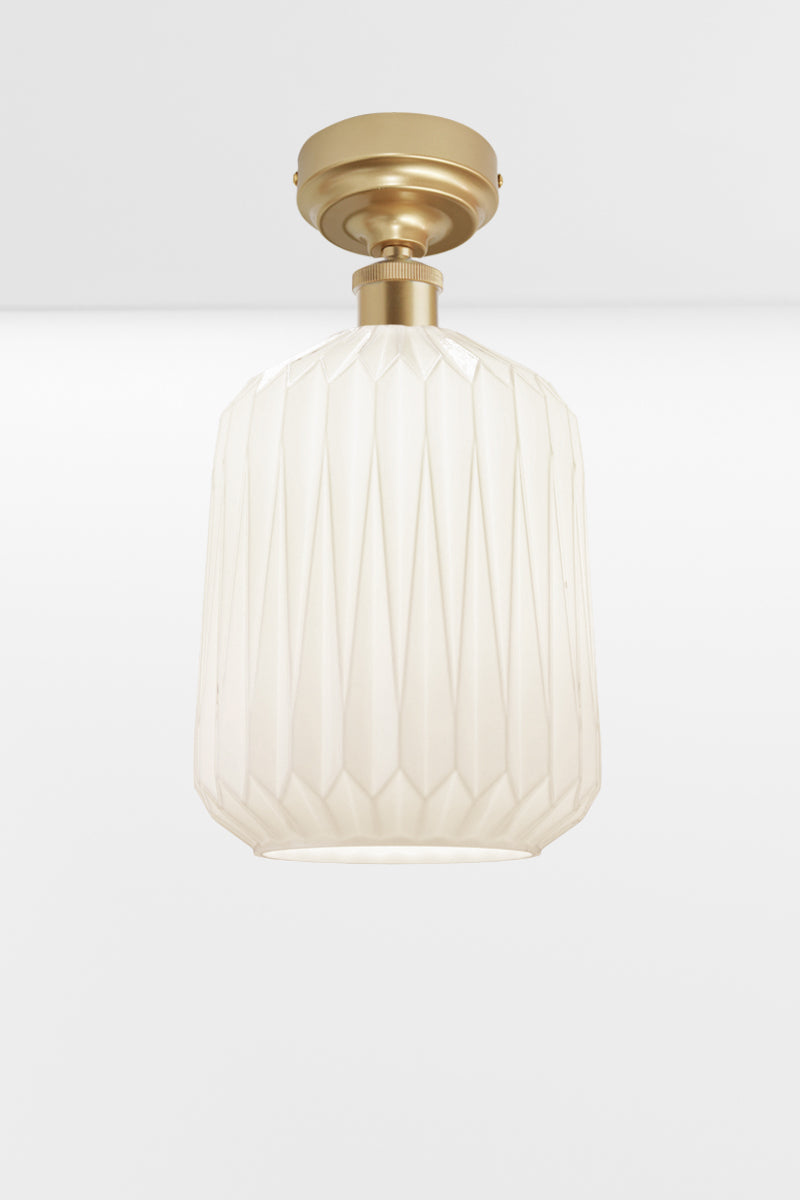 Modern geometric detailed opal glass shade, paired with a gold/brass batten holder. 