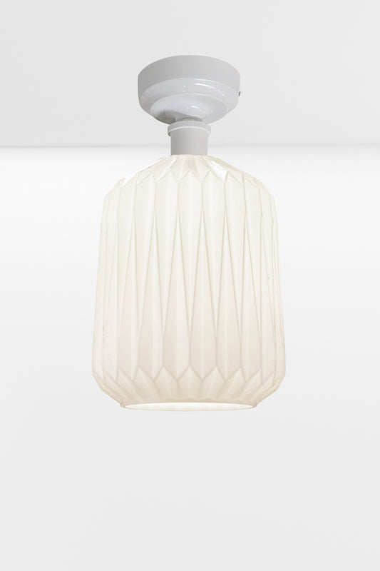 Modern geometric detailed opal glass shade, paired with a white batten holder. 