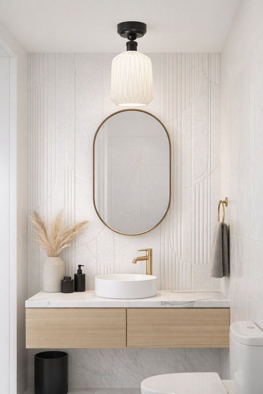 Large opal shade with geometric detailing on a black batten holder in a powderroom with art deco influences. 