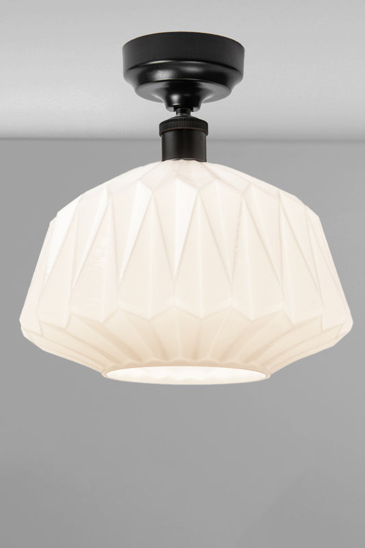 Large geometrically detailed opal shade paired with a black batten holder.