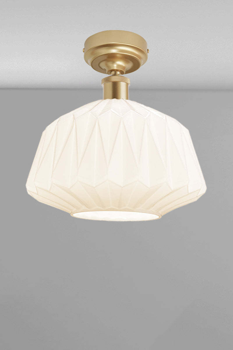 Large geometrically detailed opal shade paired with a gold/brass batten holder.