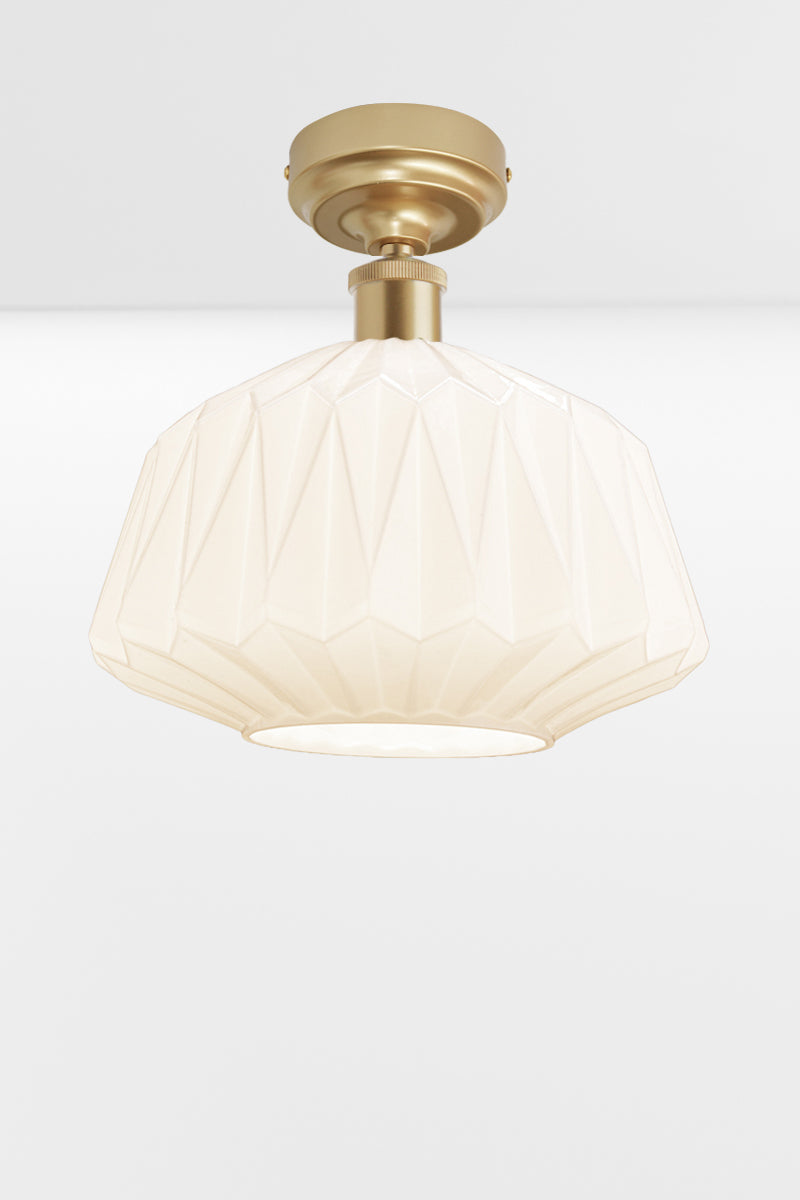 Large geometrically detailed opal shade paired with a gold/brass batten holder.