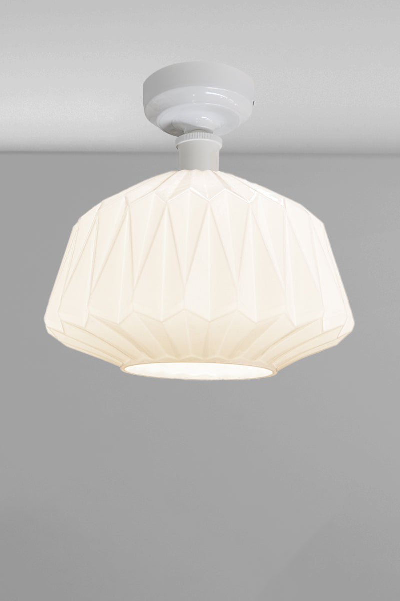 Large geometrically detailed opal shade paired with a white batten holder.