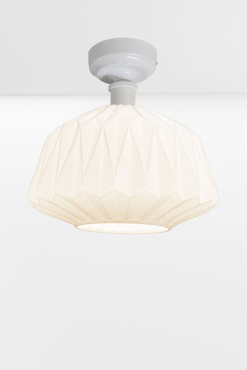 Large geometrically detailed opal shade paired with a white batten holder.