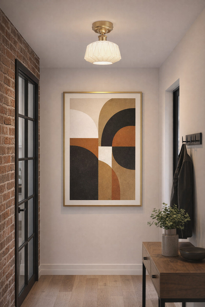 Art deco influenced geometric designed shade with a gold brass batten holder in an entranceway. 
