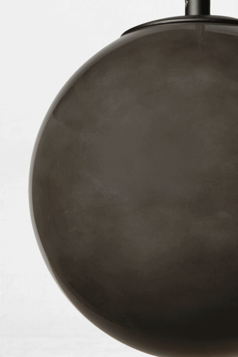 GIF of the hue change on the dark grey glass orb shade when illuminated. 