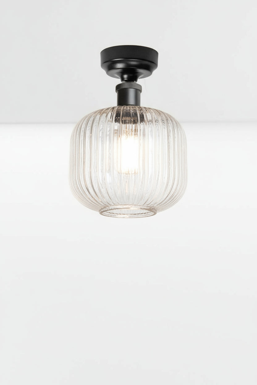 Clear reeded glass shade paired with a black batten holder. 