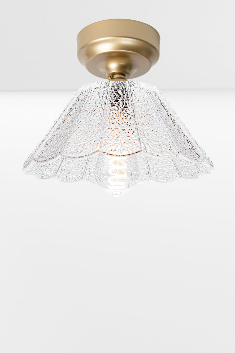  Gold Brass batten holder paired with a clear glass shade with a crackled detailling and finished with a scalloped edge. 