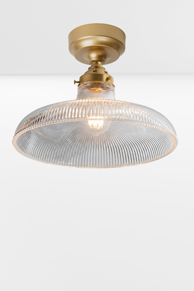 Large clear holophane glass shade on a gold/brass batten holder.