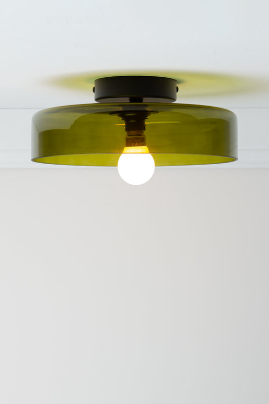 Valla Glass Ceiling Light with broad transparent green glass shade, black batten holder and exposed globe.