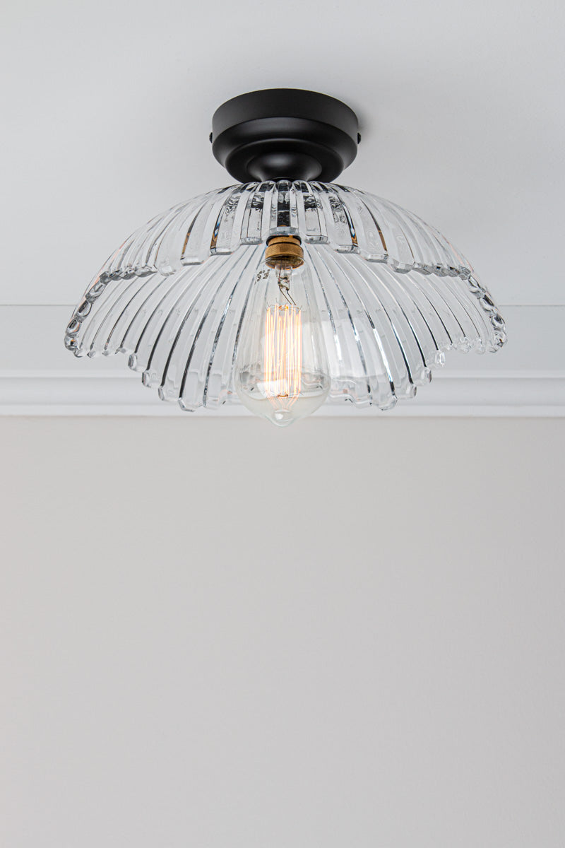 Angled view of the Hepburn Glass Ceiling Light with a black batten holder on a white ceiling. 