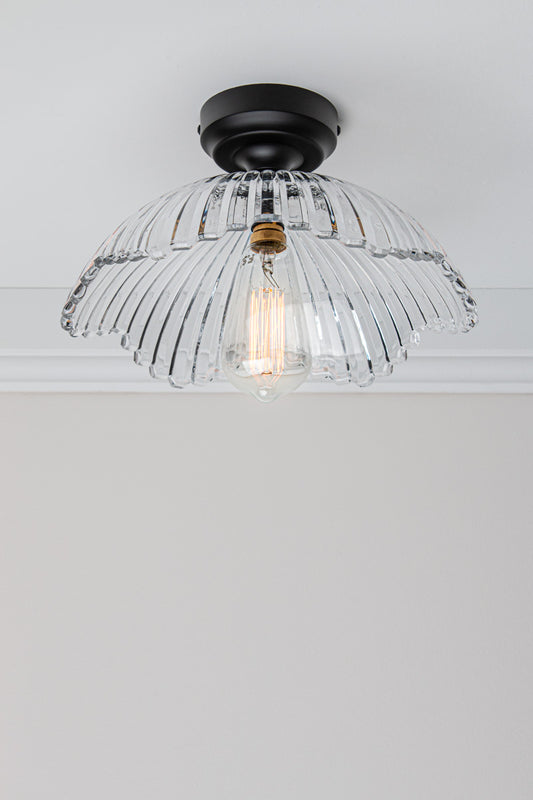Angled view of the Hepburn Glass Ceiling Light with a black batten holder on a white ceiling. 