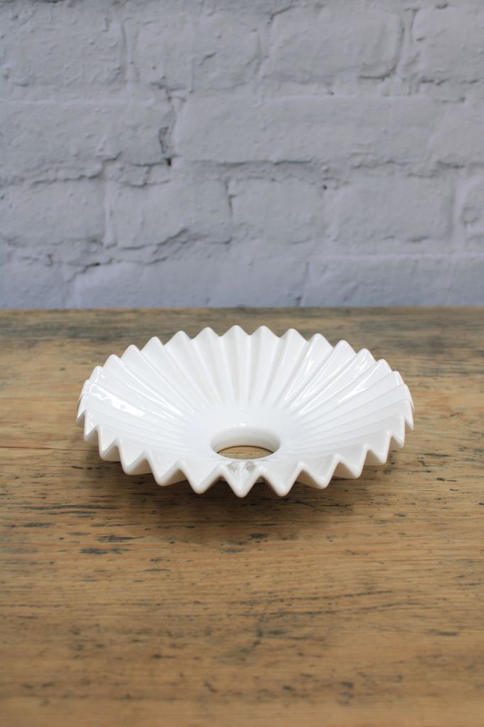 Inner view of the glazed white ceramic shad with pleated detailing.