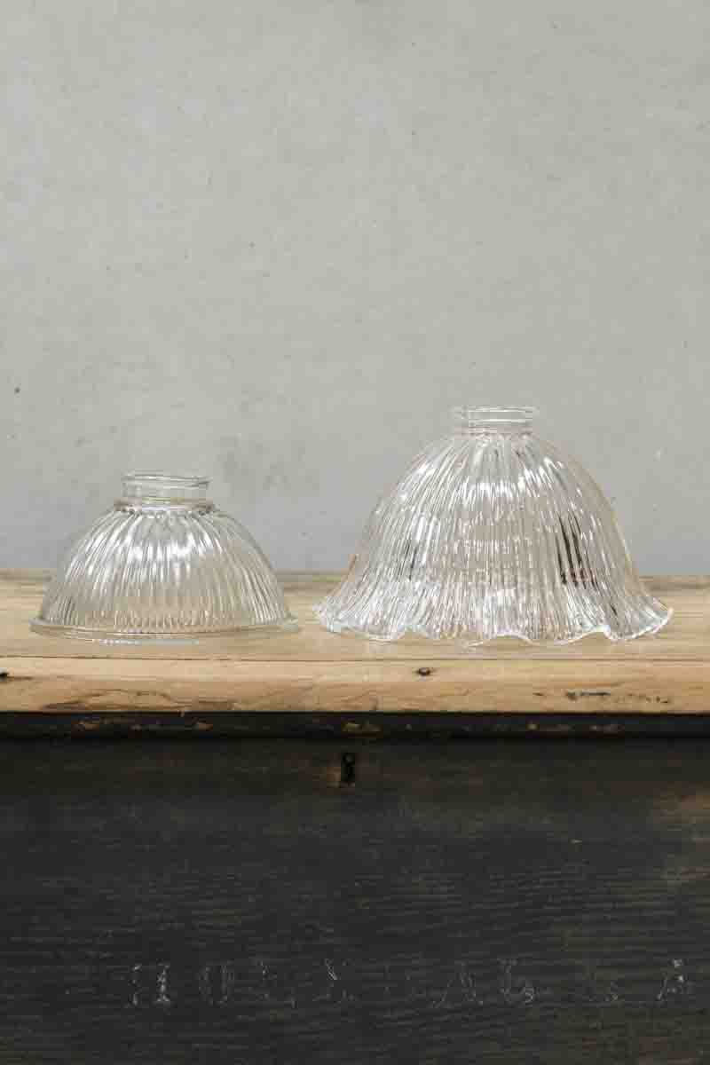 Holophane clear glass shades, one in a large size with a frilled edge, the second in a small size with a plain edge. 