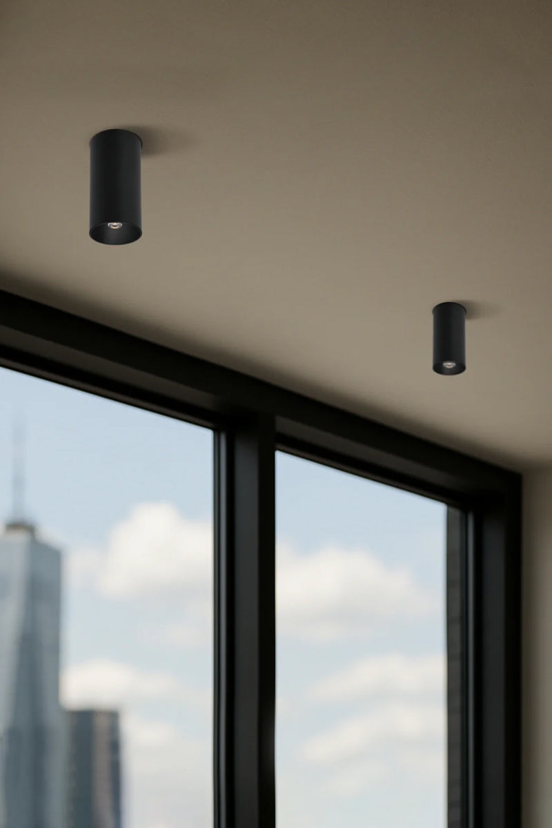 Two grey umbra finishes pin style surface mounted LED downlights on a textured white ceiling. 