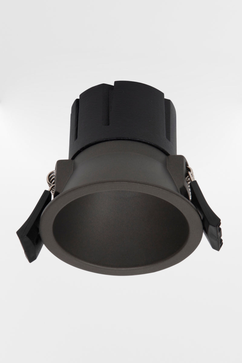 Black LED downlight, showing side clamps. 