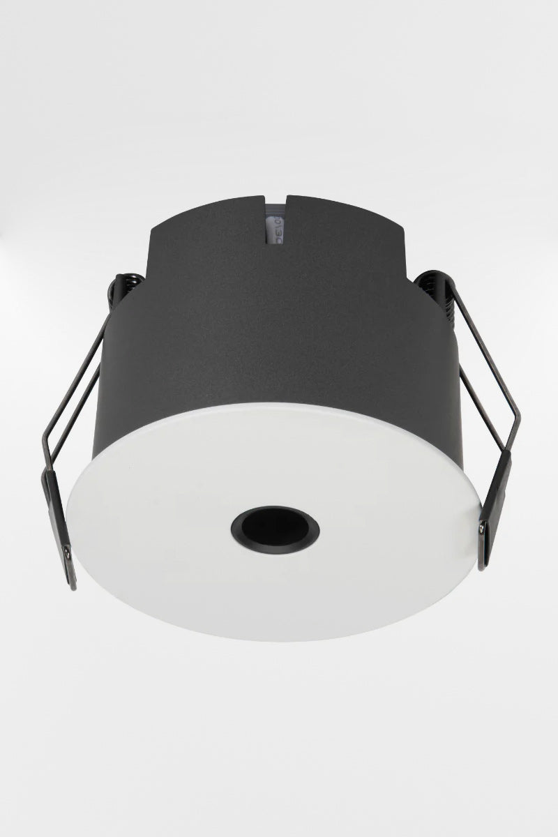 Pinhole 6W LED downlight with white face and grey body. 