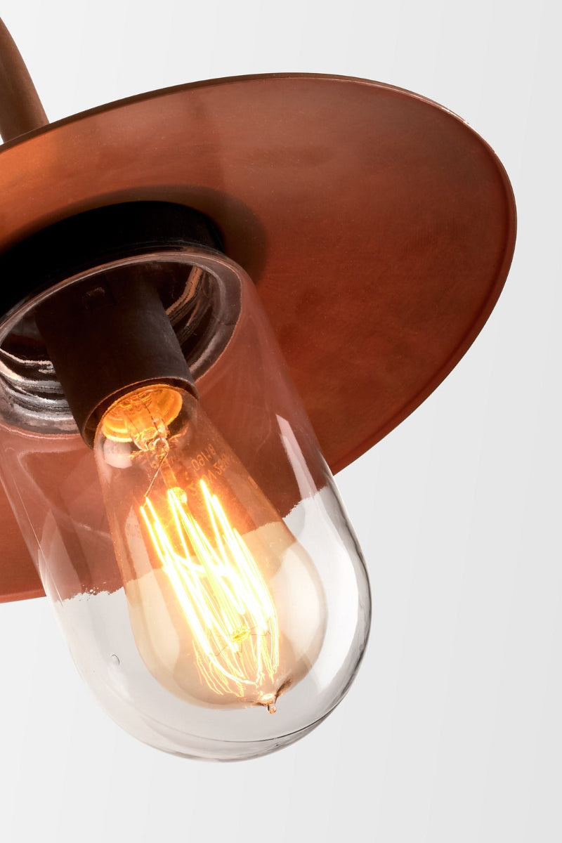 Close up of the glass cover on the copper wall light. 