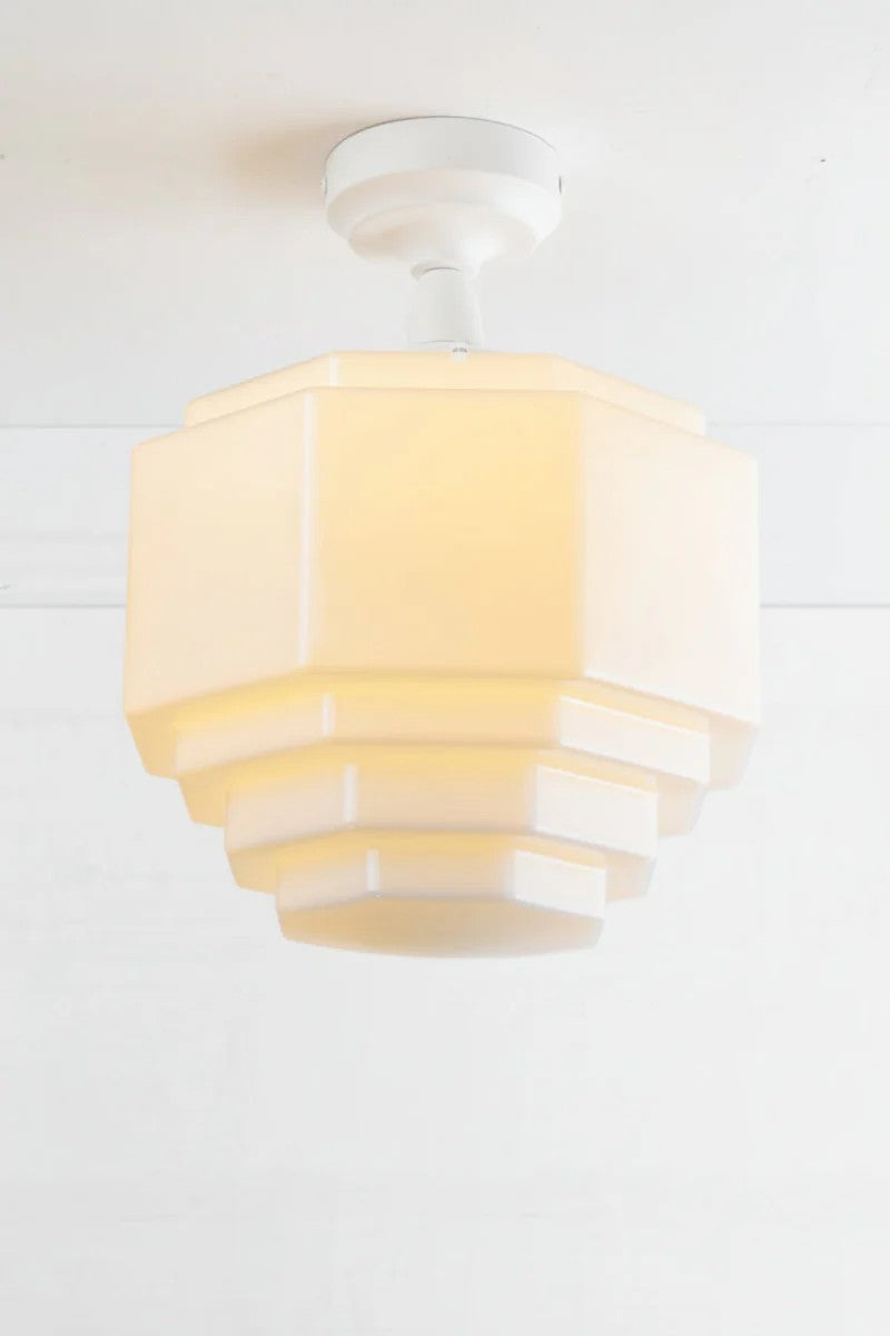 White batten holder paired with an opal stepped glass shade. 