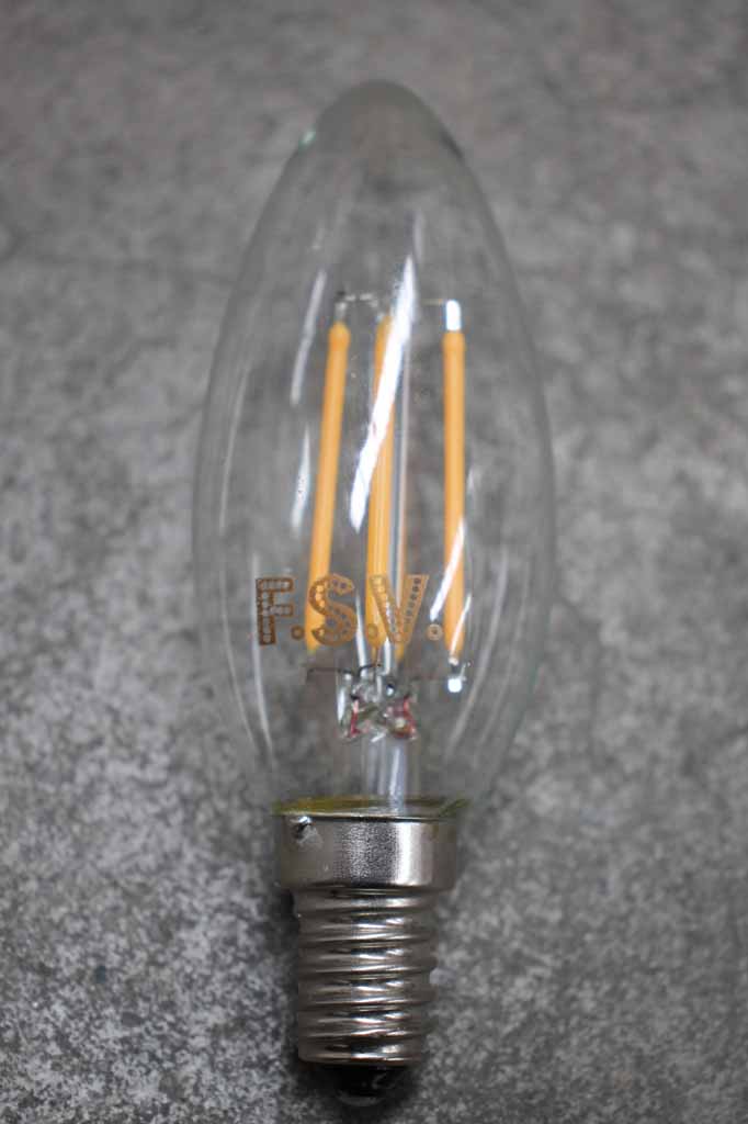 Clear glass candle LED bulb with four amber filaments and E14 screw base