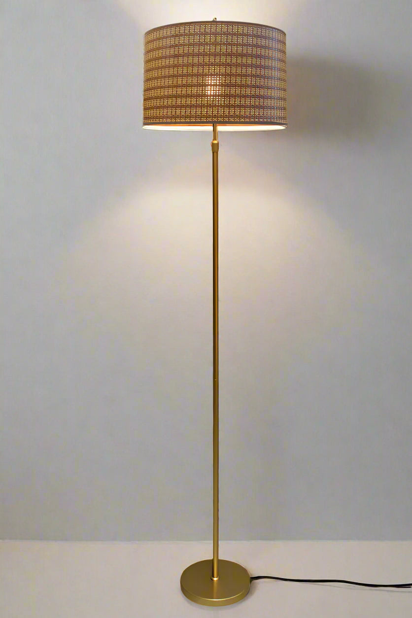 Floor lamp with gold/brass stand and organic woven shade. 
