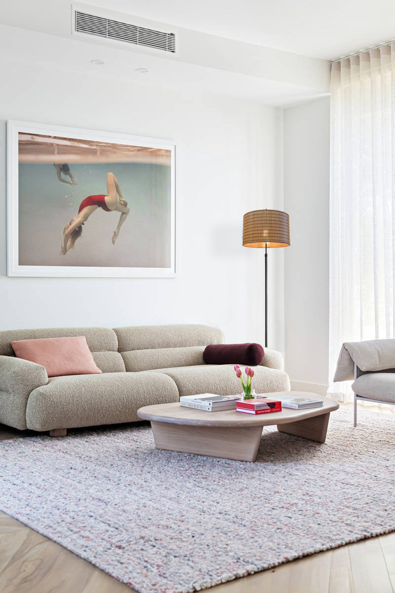 Rope floor lamp next to a sofa in a living room 
