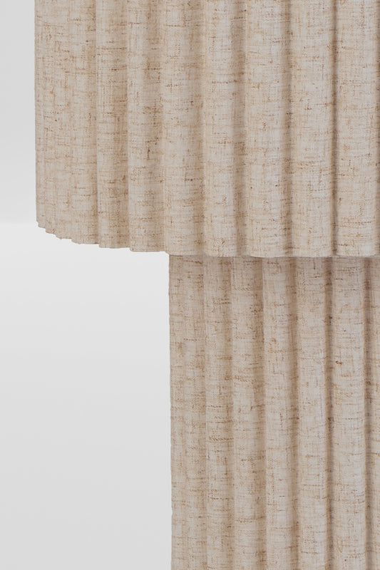 Close up of the textured fabric floor on the beige floor lamp. 
