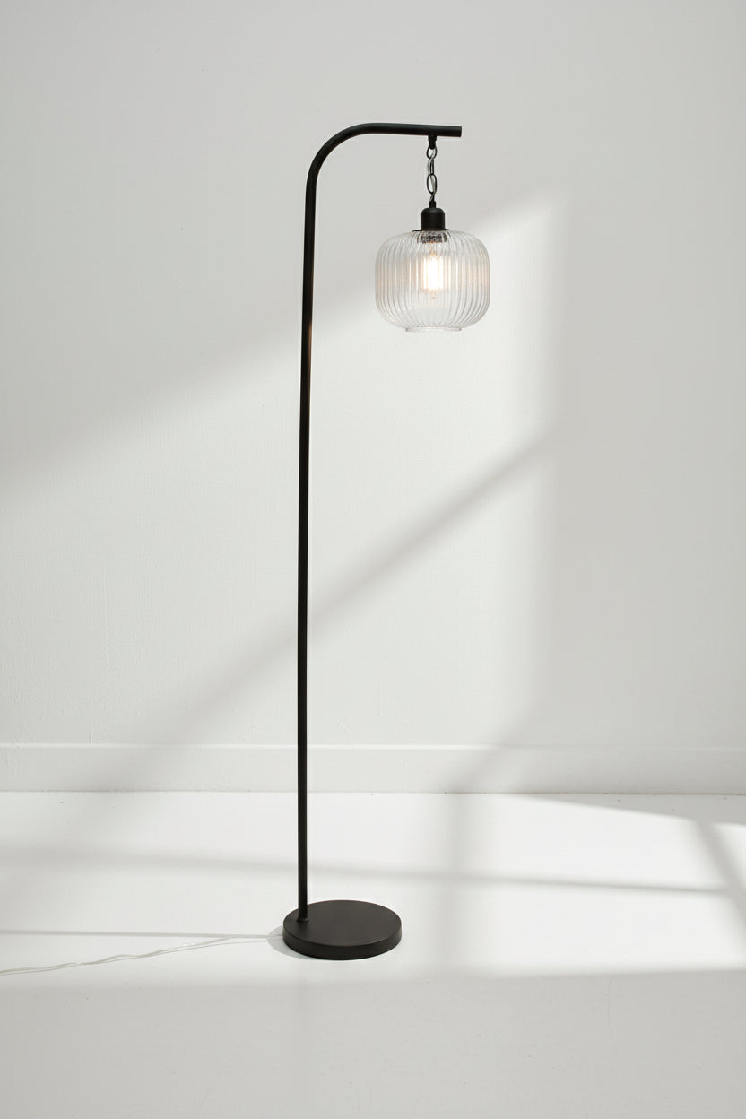 Clear reeded glass shade on a black suspension floor lamp. 