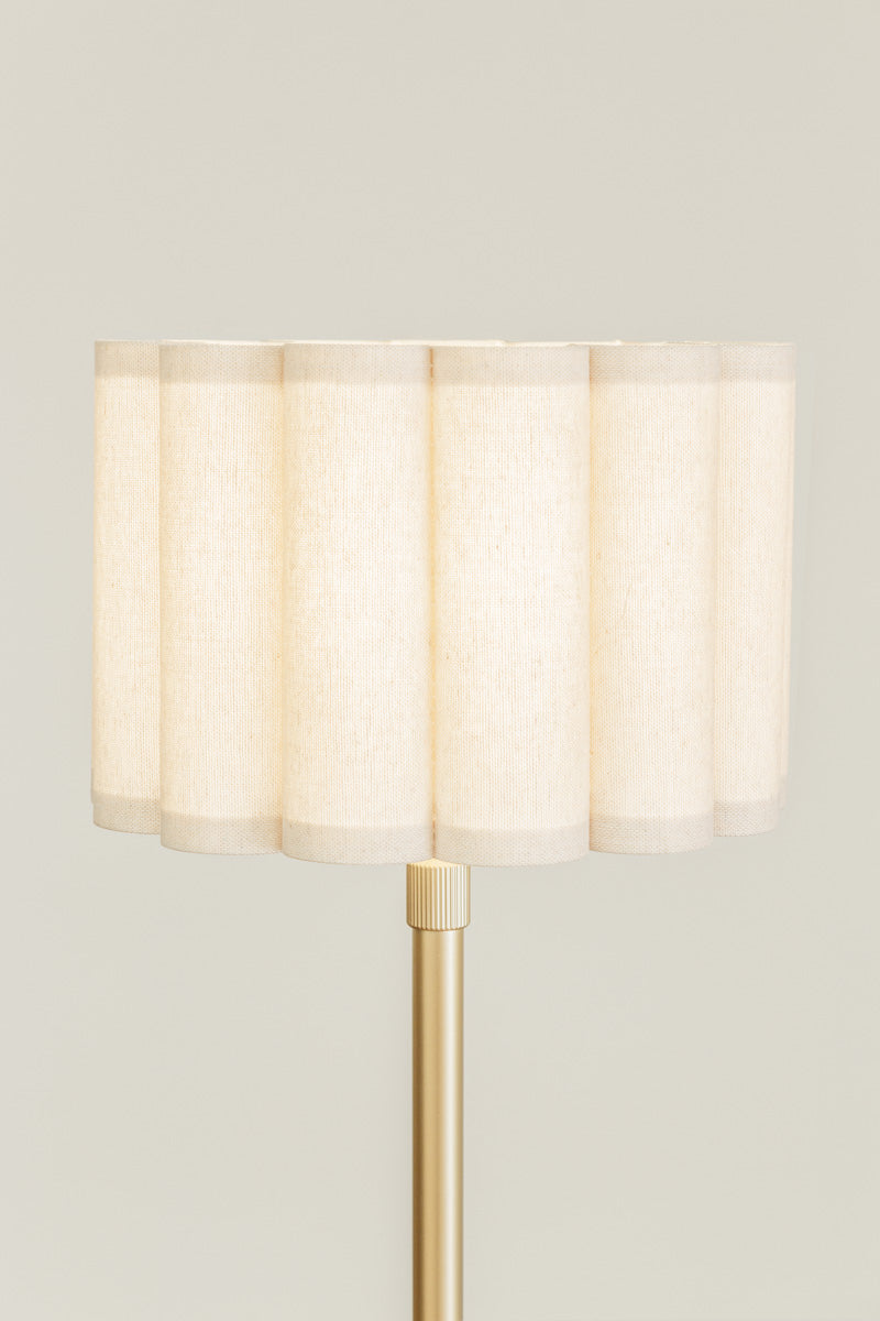 Close up of the small scalloped shade on the gold/brass floor lamp. 