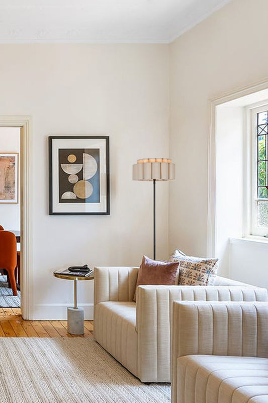 Fabric scalloped shade on a black candlestick floor lamp in a frech living space!