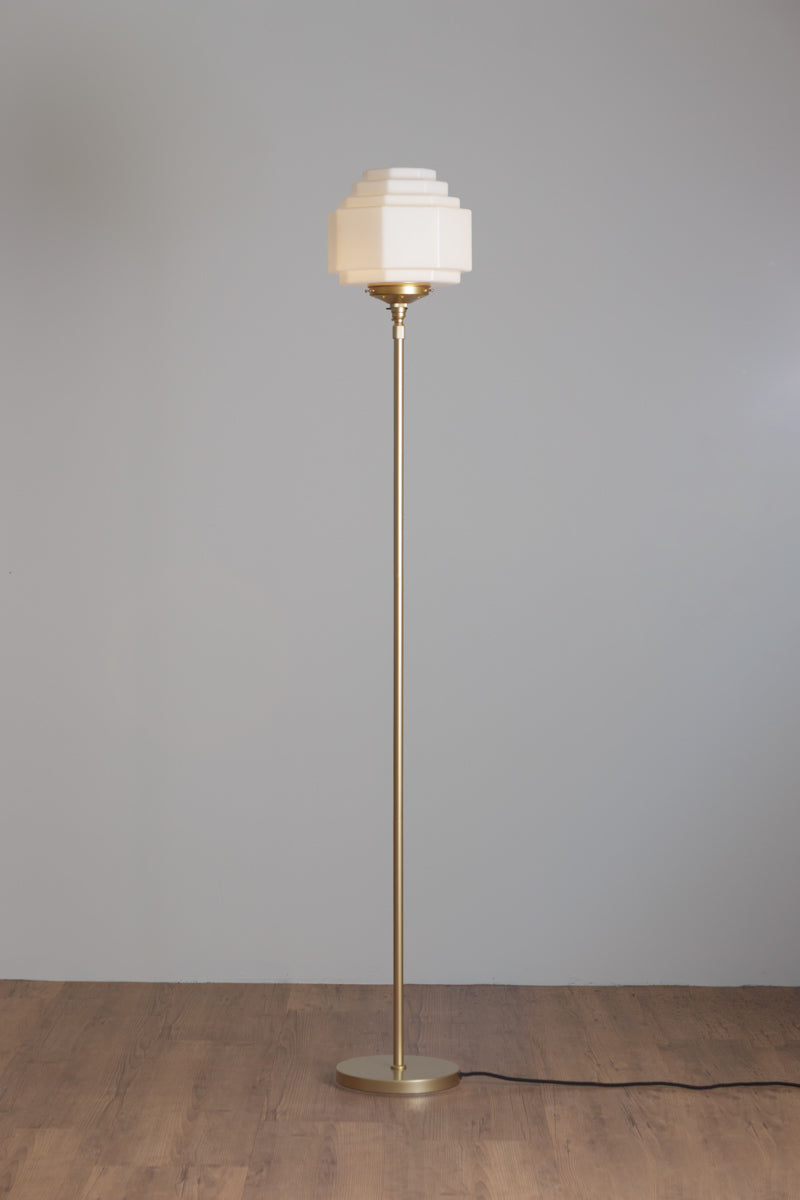 Gold/brass floor lamp stand paired with an opal stepped style glass shade.