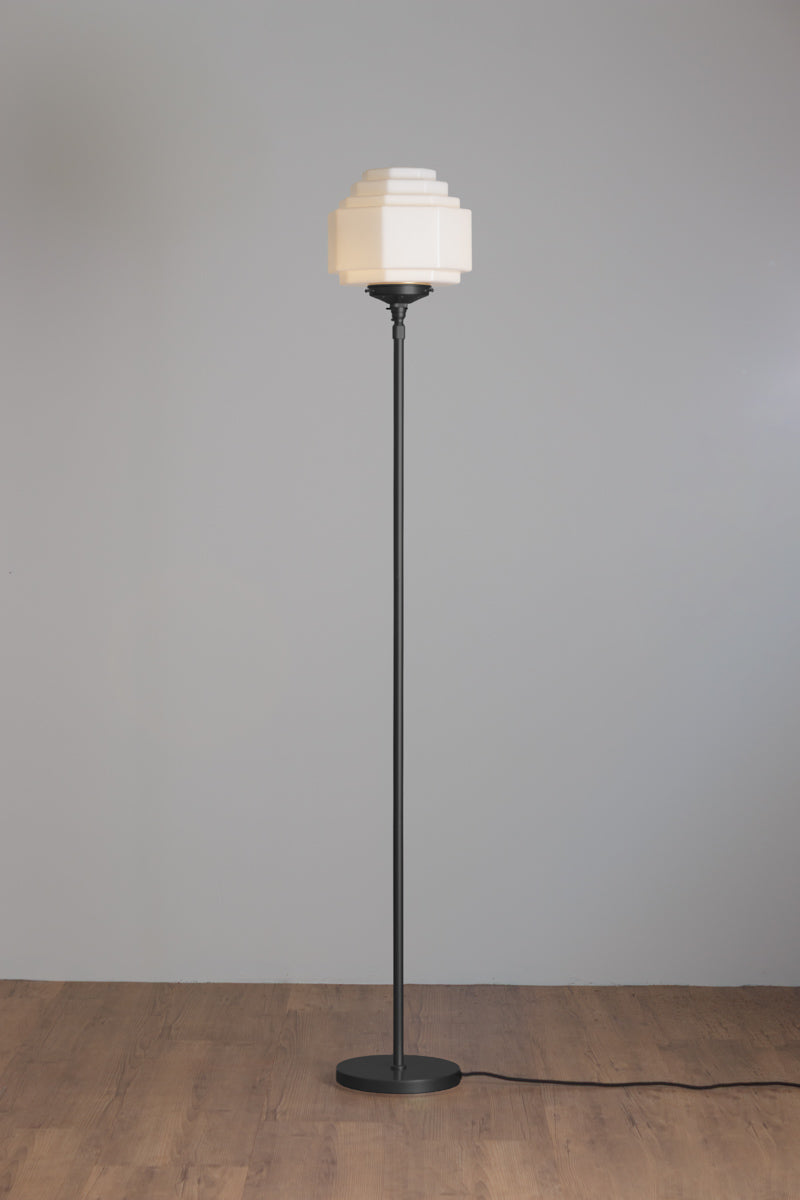 Black floor lamp stand paired with an opal stepped style glass shade.