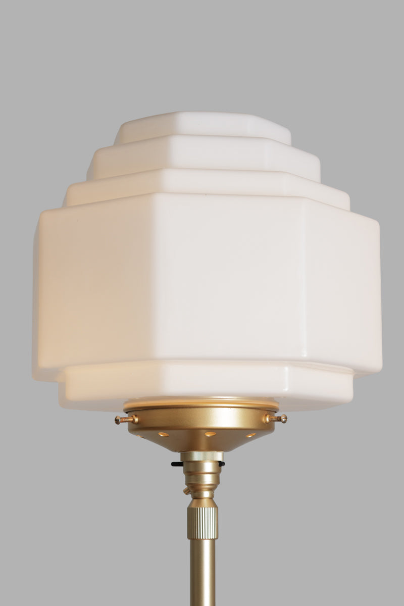 Opal stepped style glass shade on a gold/brass gallery and floorlamp stand. 