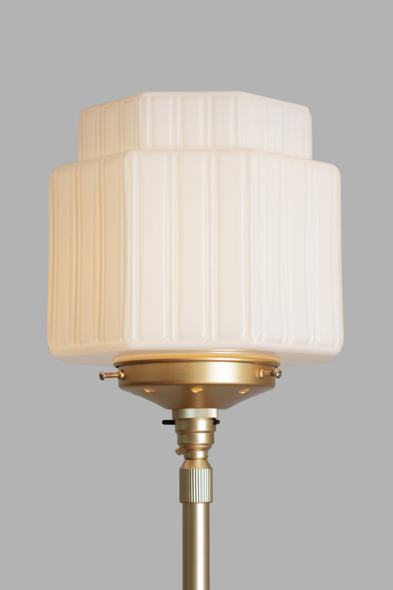 Cropped image of the opal art deco inspired glass shade on the Gold/brass floor lamp. 