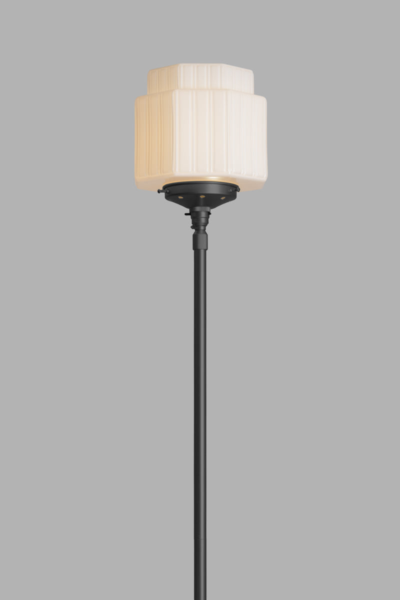 Cropped image of the opal art deco inspired glass shade on the black floor lamp. 