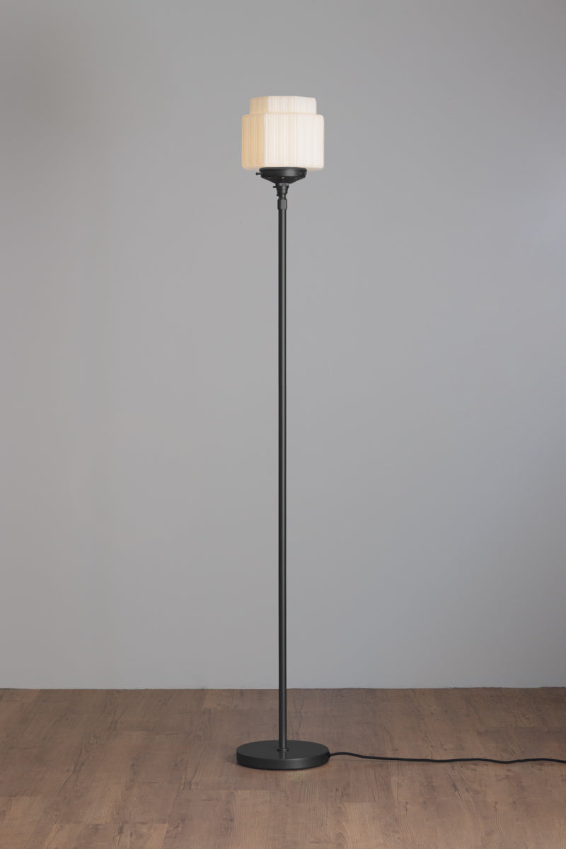 Black stem floor lamp with an opal art deco inspired glass shade. 