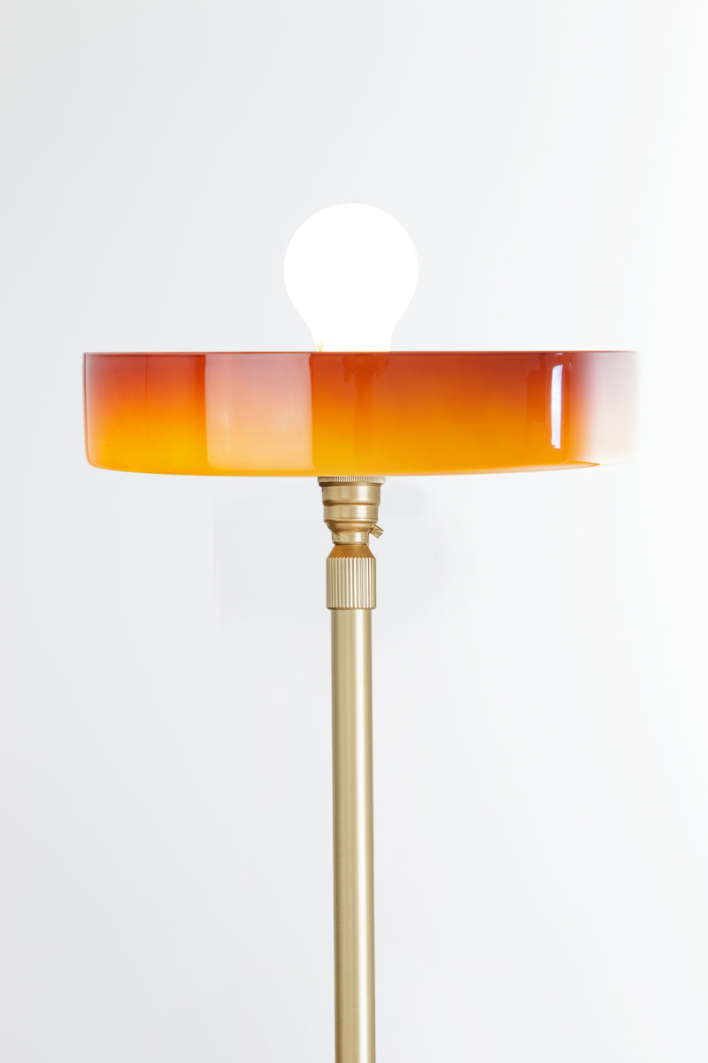 Amber Gambier shade on a gold/brass floor lamp stand
