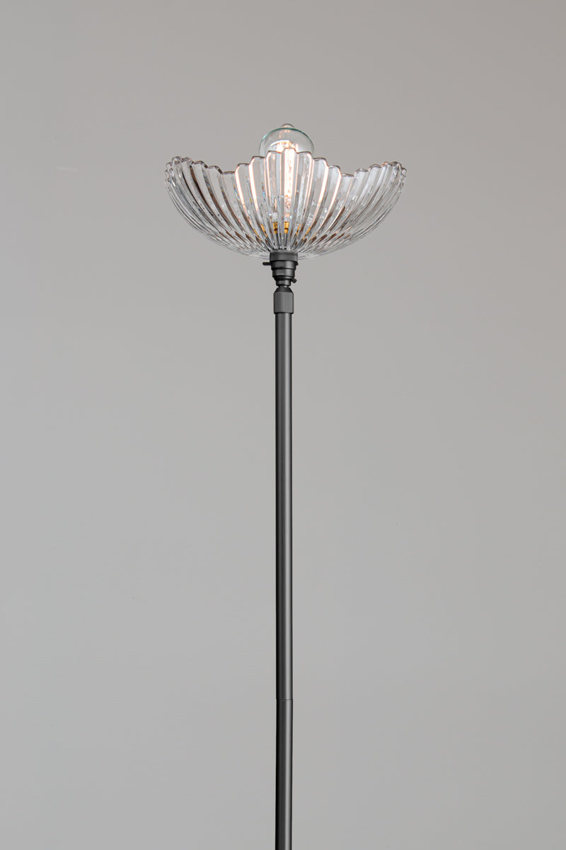 Close up of the Hepburn Glass Floor Lamp with a black stand.