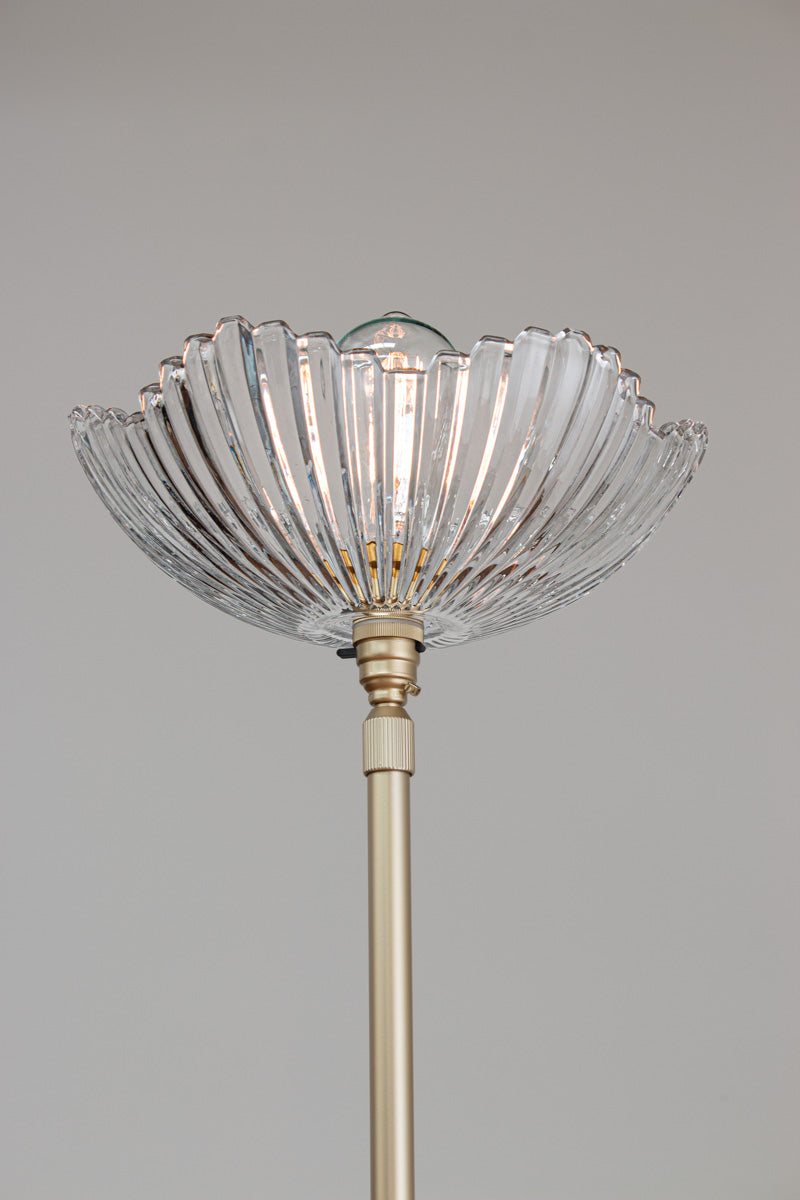 Close up of the Hepburn Glass Floor Lamp with a gold/brass stand.