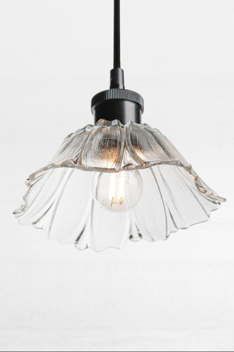 Honfleur clear glass pendant light with decorative fluted shade, black suspension and exposed globe.