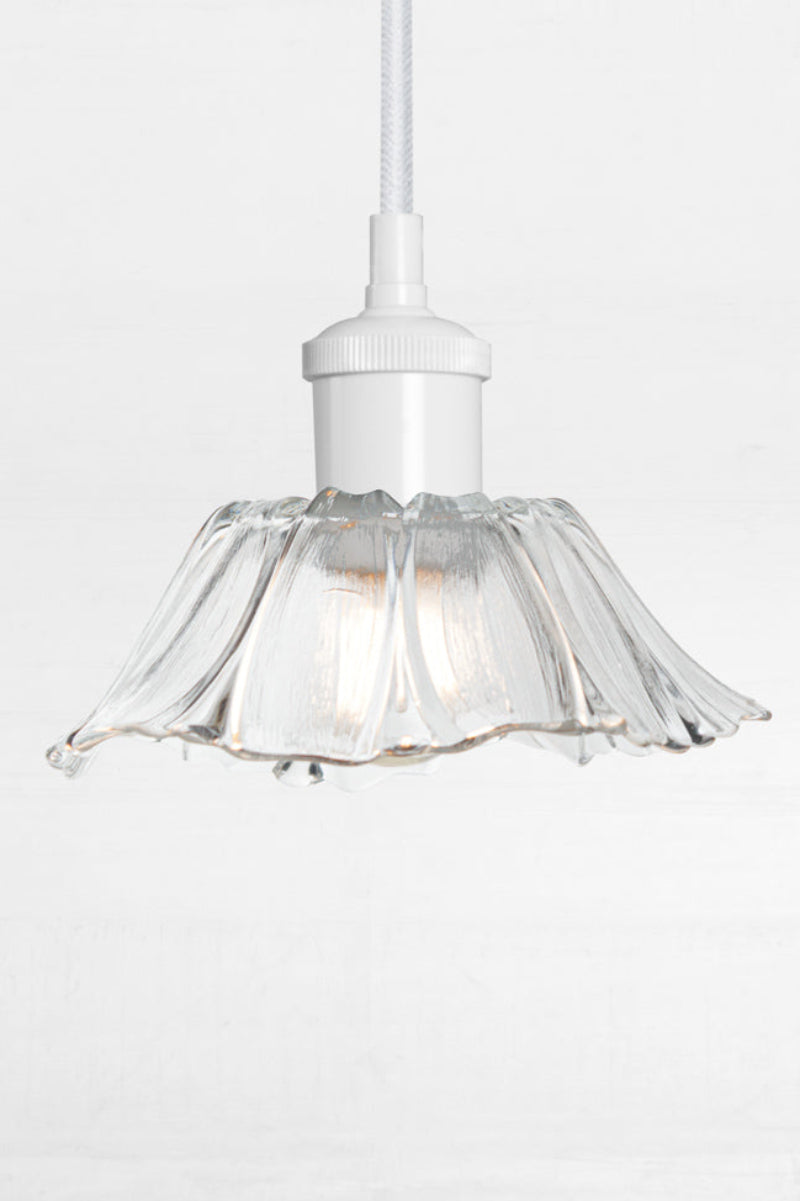 Honfleur clear fluted glass pendant light with white suspension cord and matching white metalware.