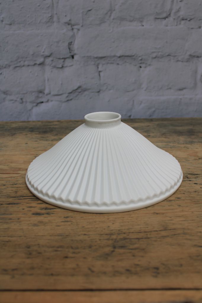 Uninstalled white, pleated ceramic shade. 