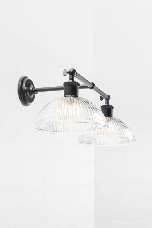 Double wall sconce with two ridged glass shade helps diffuse light