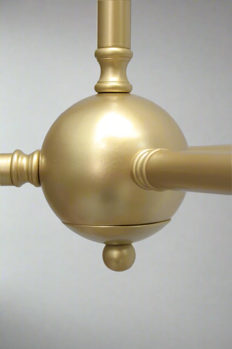 Center junction ball of the gold/brass 3 arm fixture. 