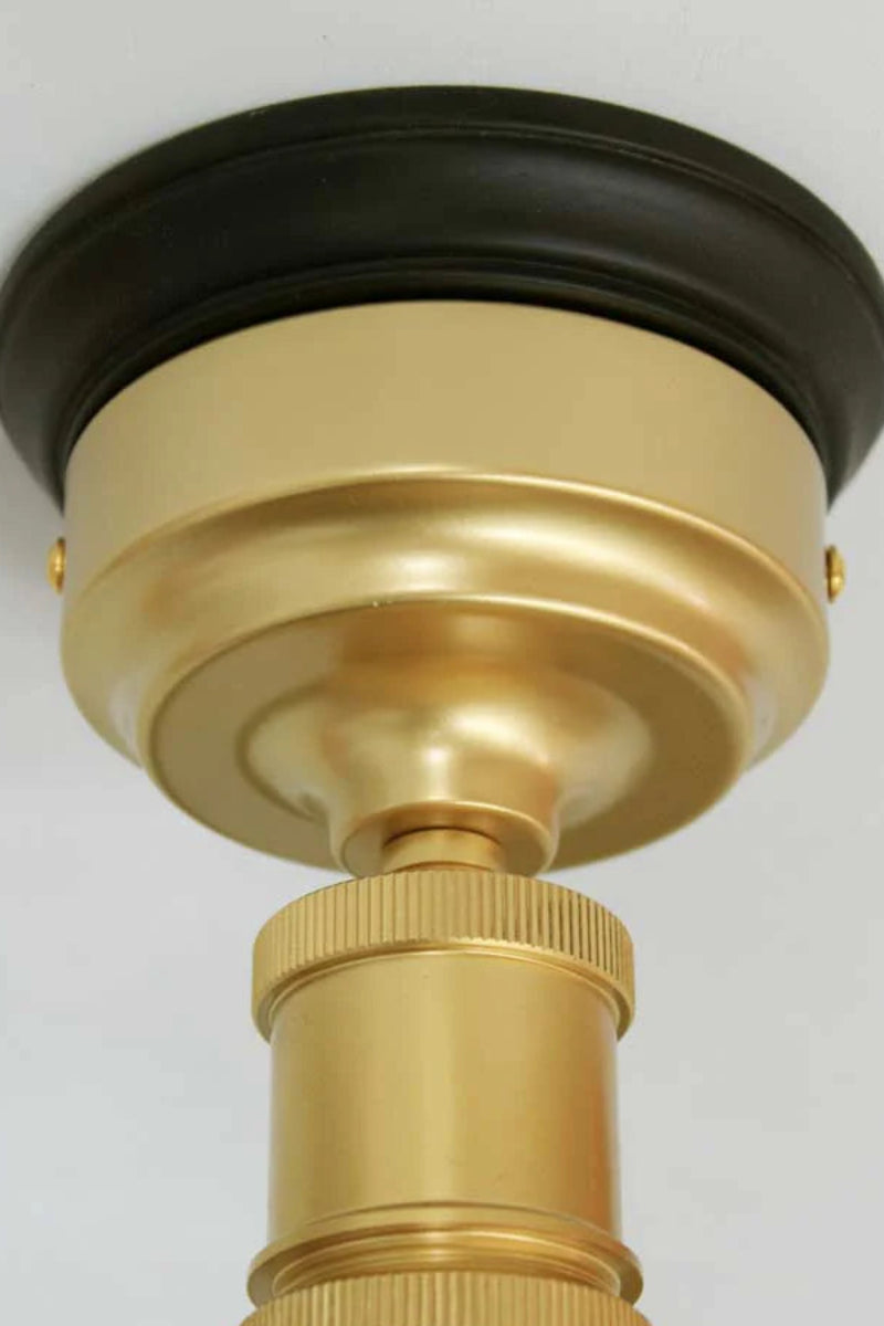 batten holders in gold/brass, on black wooden block
