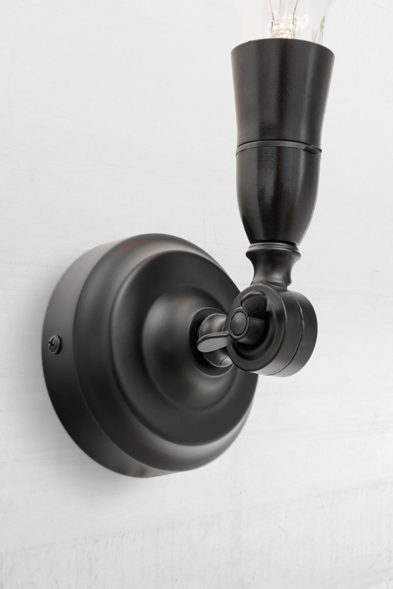 Black batten holder with adjustable lampholder facing upwards. 