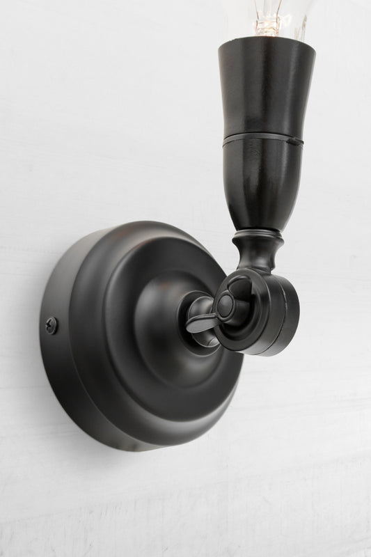 Black batten holder with adjustable lampholder facing upwards. 