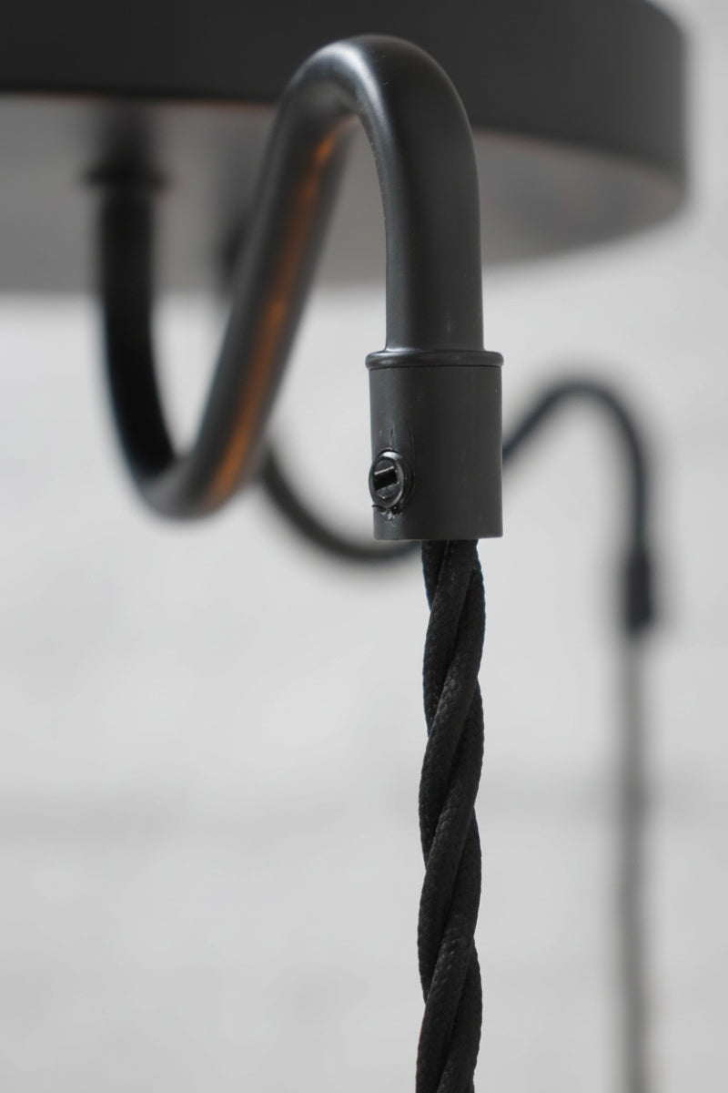 Close up of the matt black gooseneck arm of the multi drop pendant fixture. 