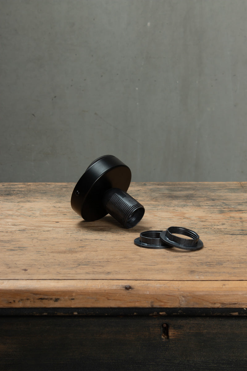 Black batten Holder and O rings on wood bench.